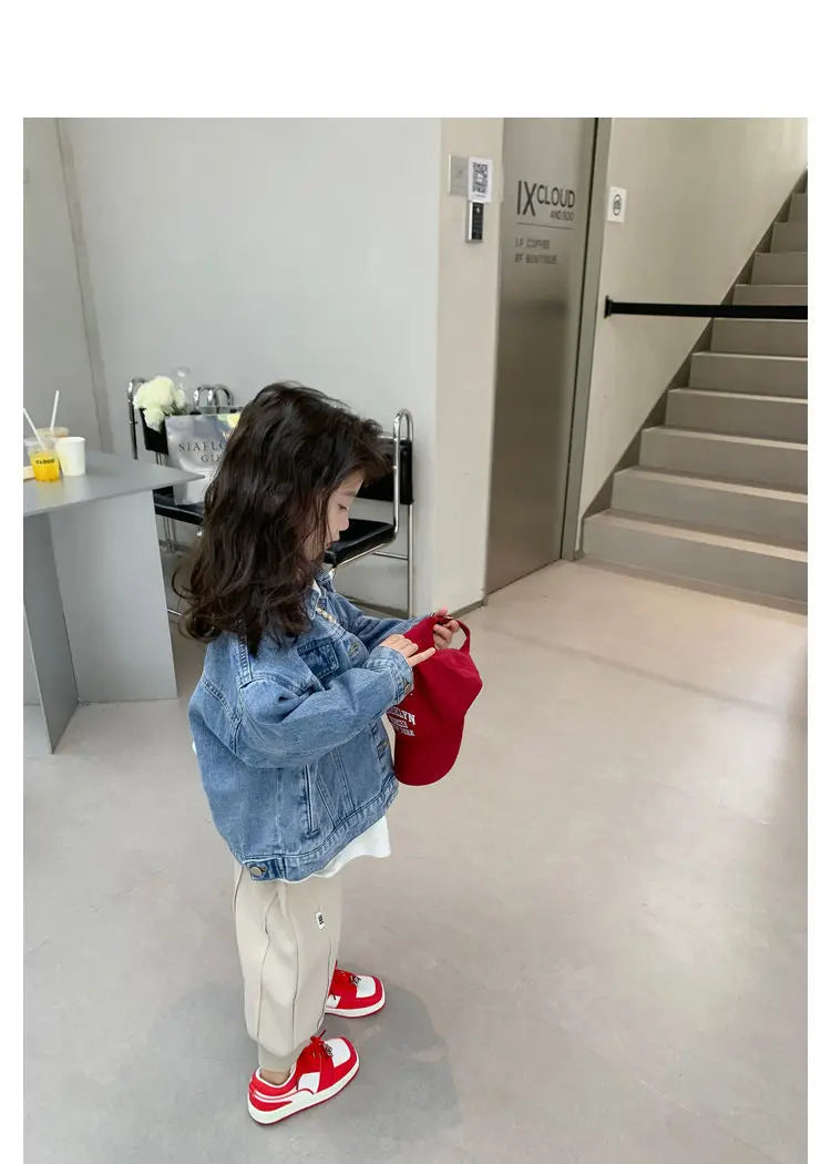 Fashion Kids Denim Jacket Girls Spring Autumn Casual Coat Children Outerwear worn by girl holding red hat indoors