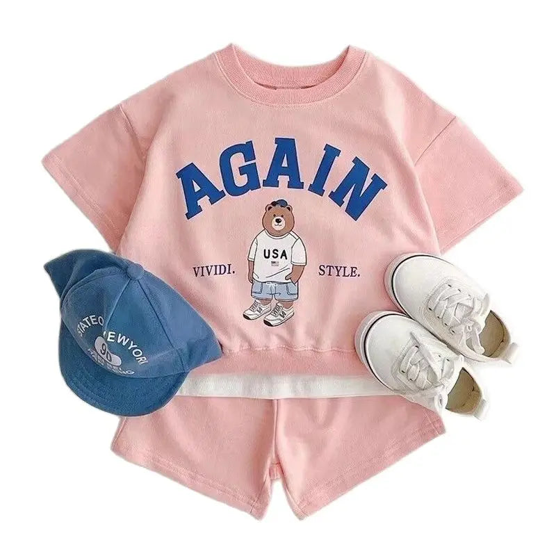 Fashion Kids Sports Bear Sweatshirt and Pants 2 Piece Fall Clothing Set in pink with bear graphic, blue cap, and white sneakers