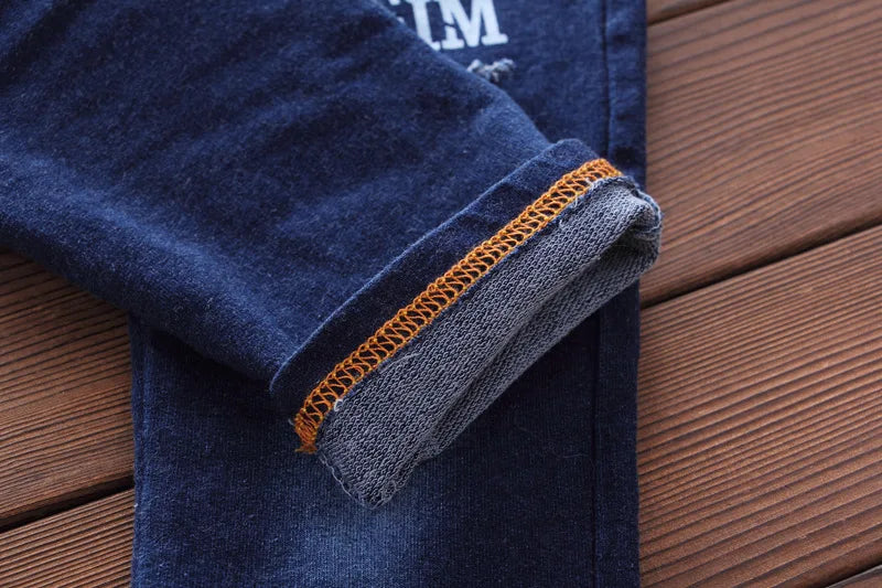 Fashion Spring Autumn Boys Denim Sports Set Kids Outfit Casual Clothes showing close-up of dark blue denim sleeve with orange stitching