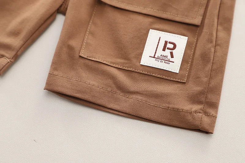 Close-up of brown denim shorts pocket detail with patch from Fashion Summer Kids Cartoon T-Shirt and Denim Shorts 2PCS Casual Outfit Set