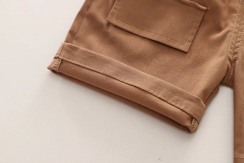 Close-up of brown denim shorts detail from Fashion Summer Kids Cartoon T-Shirt and Denim Shorts 2PCS Casual Outfit Set