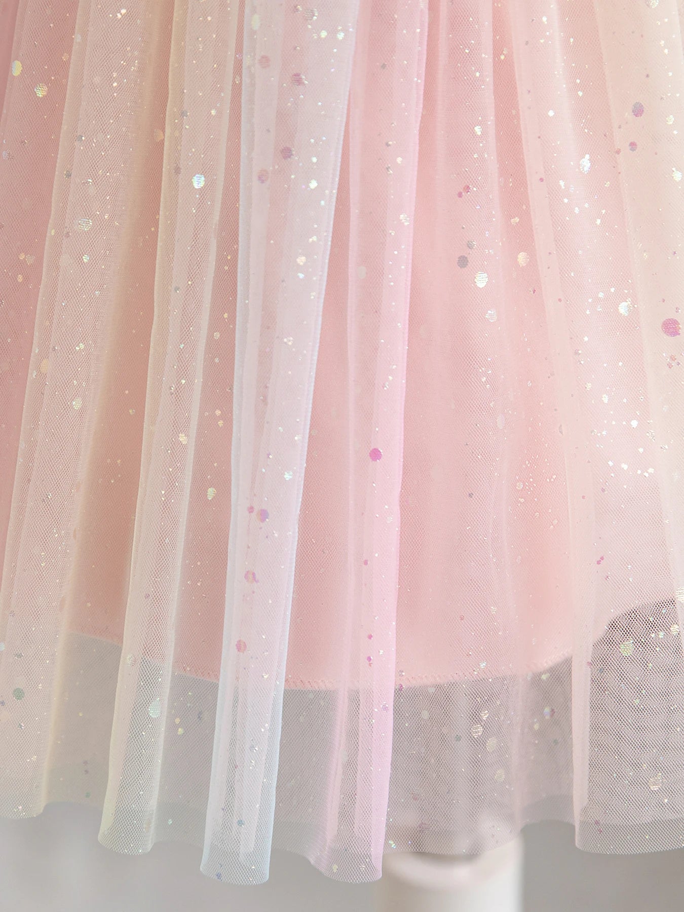 Close-up of pink tulle fabric with sparkling sequins from Girl Rainbow Sequins Tulle Birthday Party dress
