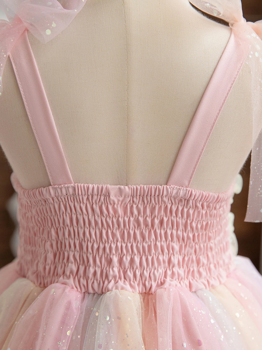 Close-up of the back of Girl Rainbow Sequins Tulle Birthday Party dress with pink straps and ruched waist