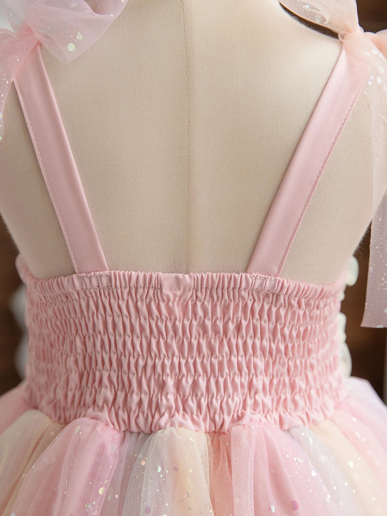 Close-up of the back of Girl Rainbow Sequins Tulle Birthday Party dress with pink straps and ruched waist
