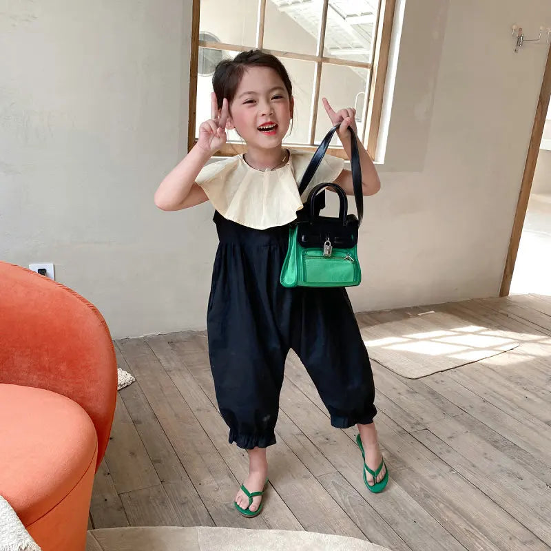 Cute little girl wearing Girls Fashion Casual Cotton Sets Spring Autumn Raglan Sleeve Sweet Baby Clothes holding a green handbag