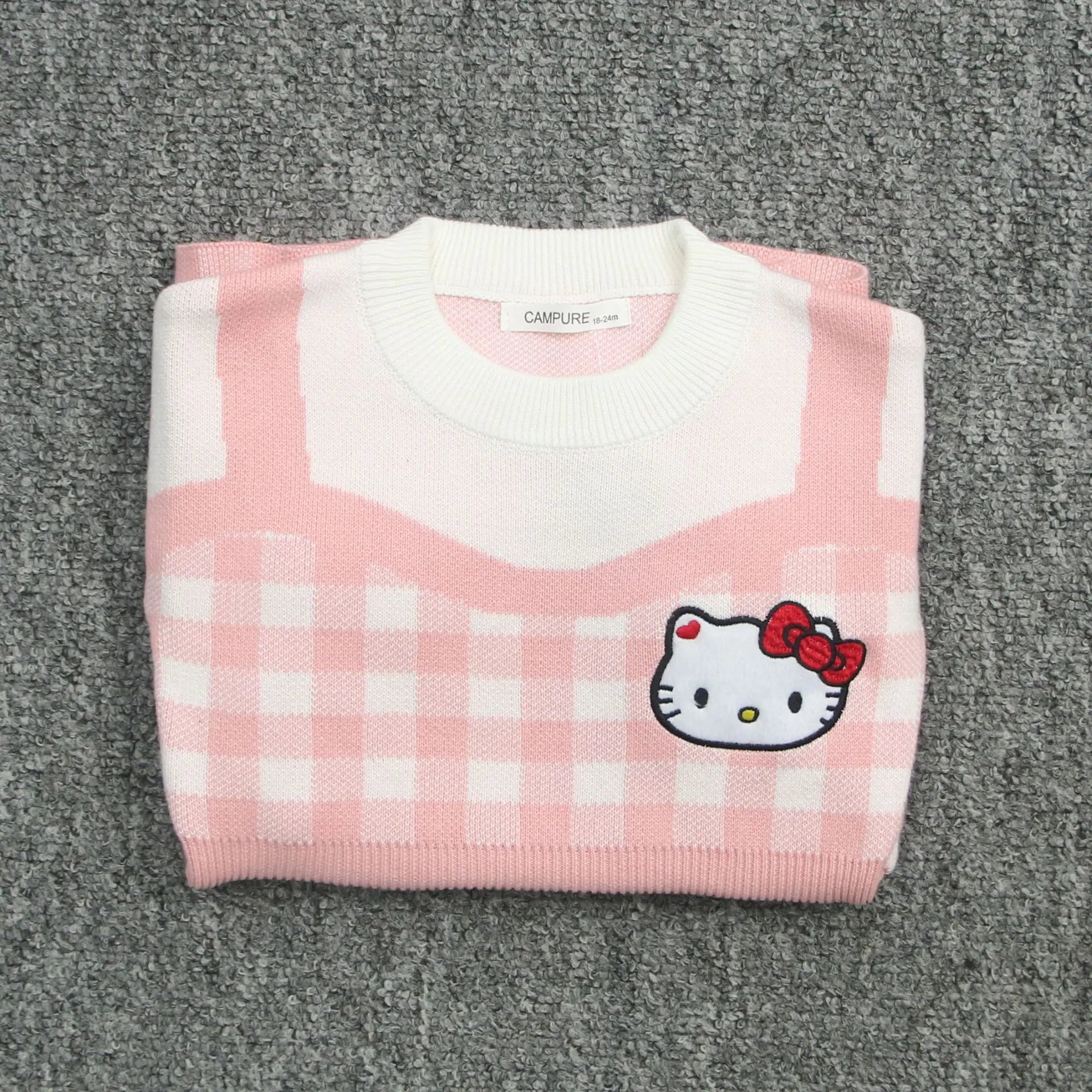 Girls Kawaii Hello Kitty Pink Knitted Cotton Princess Dress Cute Cartoon Style folded on gray carpet