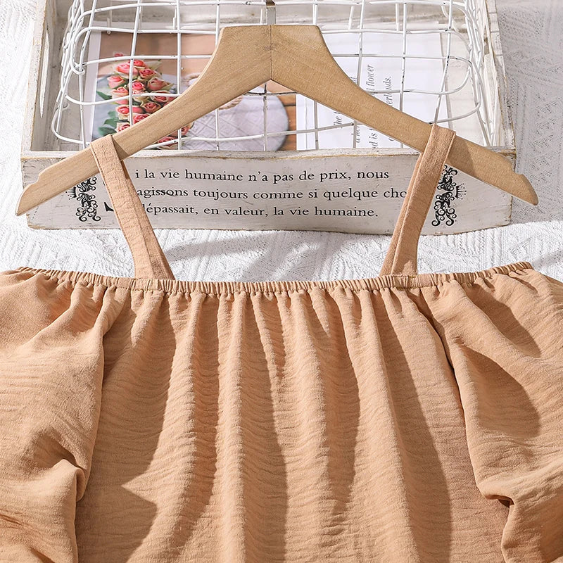 Girls Khaki Off-Shoulder Top & Striped Pants Set Summer Resort Outfit close-up of khaki off-shoulder top on wooden hanger