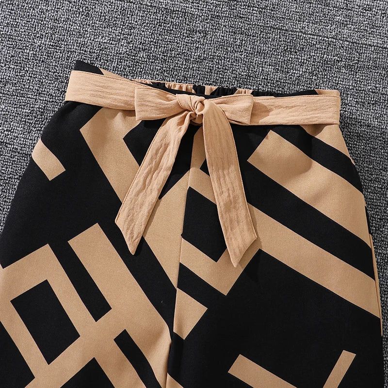 Girls Khaki Off-Shoulder Top and Striped Pants Set summer resort outfit showing patterned black and khaki striped pants with a tied waist belt