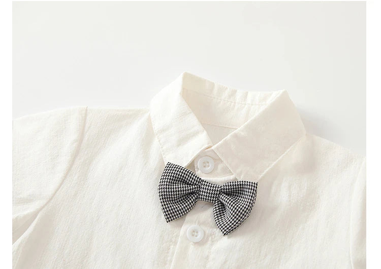 Close-up of boys white short sleeve shirt featuring a black and white checkered bow tie from Boys White Short Sleeve Shirt and Shorts Two-Piece Summer Party Outfit