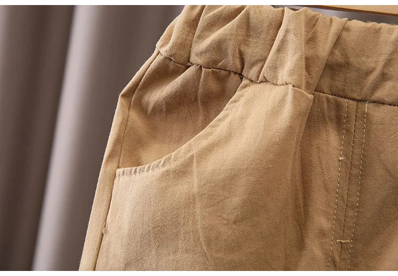 Close-up of beige toddler pants pocket and elastic waistband from Kids Boys Cartoon Clothing Set Baby T-Shirt Pants Toddler T-shirt Shorts Outfit