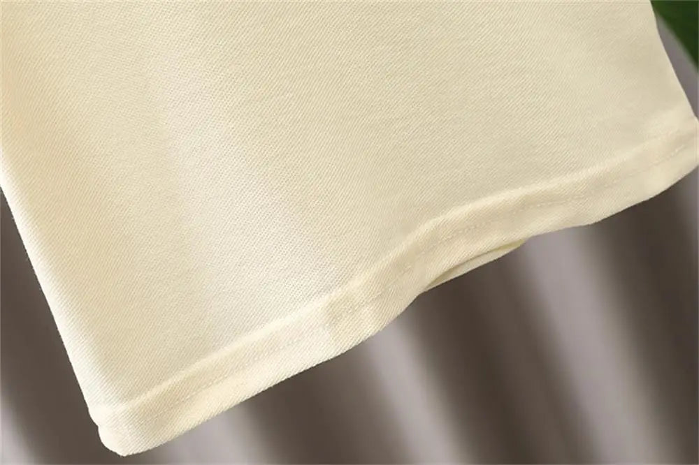 Close-up of soft cream fabric hem detail for Kids Boys Summer Two-Piece Set New Baby Outfit Trendy Casual Fashion Clothing