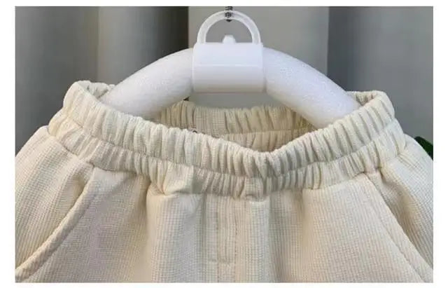 Close-up of cream color kids boys summer vest set new fashion baby net red clothes two piece outfits elastic waistband
