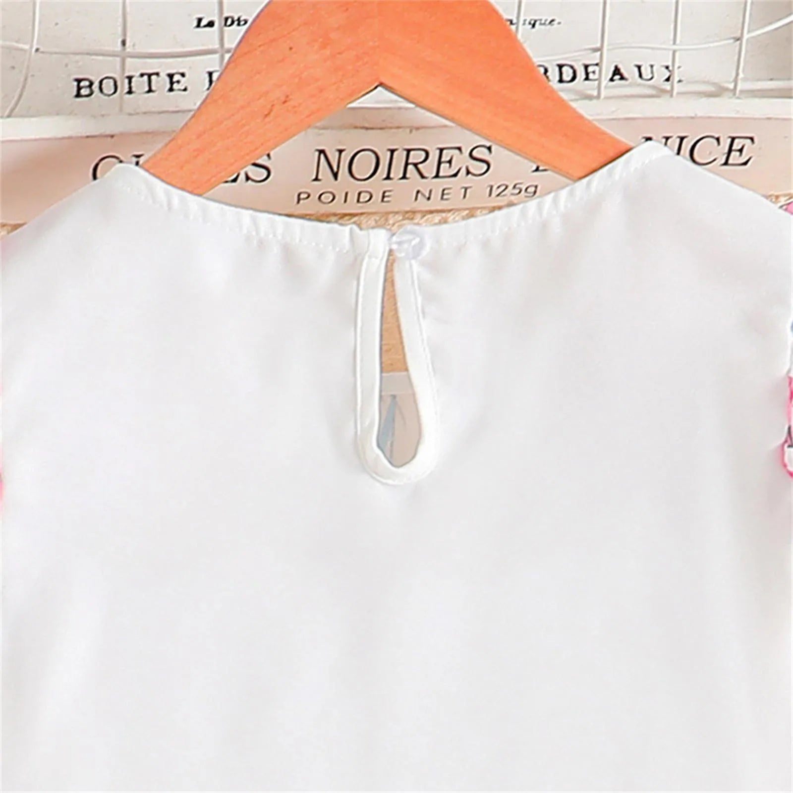 Back view of white top with keyhole button detail from Kids Casual Clothing Sets Summer Girls Fashion Rose Floral Print White Top Pants