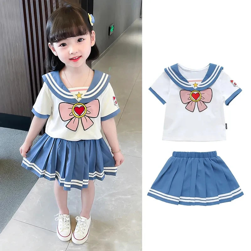 Kids Girls Cartoon Bow T-Shirt and Pleated Skirt Set Sailor Moon Cosplay Outfit in white and blue worn by a young girl