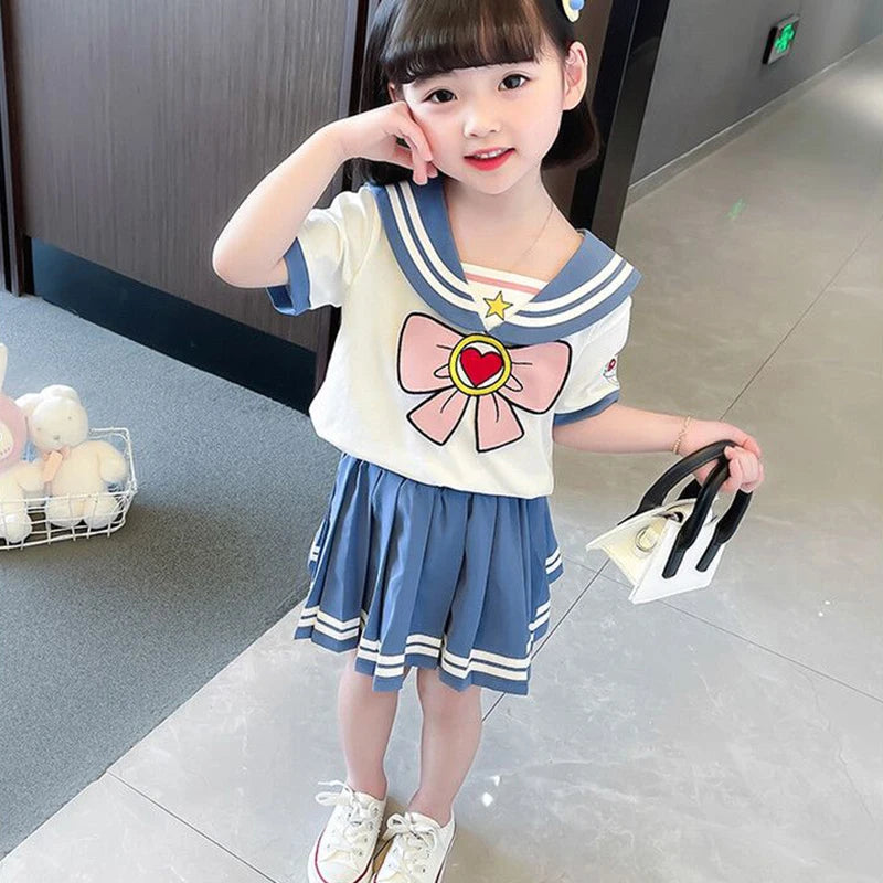 Kids Girls Cartoon Bow T-Shirt and Pleated Skirt Set Sailor Moon Cosplay Outfit worn by a young girl with white shoes