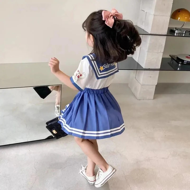 Kids girls cartoon bow T-shirt and pleated skirt set Sailor Moon cosplay outfit worn by child in white sneakers