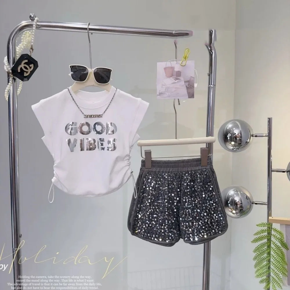 Kids Girls Summer Outfit Set Sleeveless T-shirt and Shiny Shorts 2-Piece Set by Yamza Tots Closet displayed on hanger with sunglasses