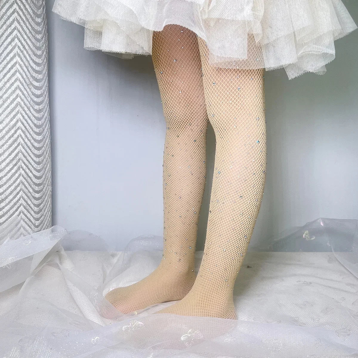 Kids Rhinestone Glitter Fishnet Tights Baby Girl Stockings Socks Accessories in white worn by a child with a tutu skirt