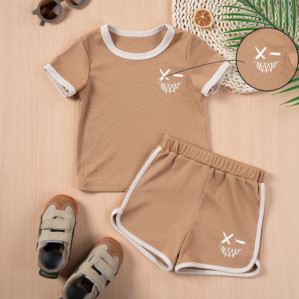 Kids Summer Fashion 2pcs Casual Printed Unisex T-Shirt and Shorts Set in light brown with white trim and graphic design