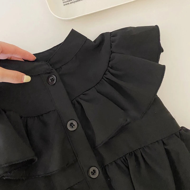 Close-up of Korean Kids Summer Black Fly Sleeve Layered Dress Girls Fashion Outfit Clothes showing button details and layered ruffle sleeves
