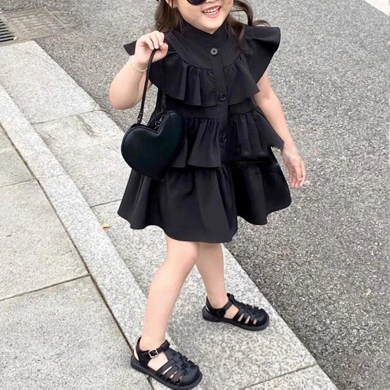 Korean Kids Summer Black Fly Sleeve Layered Dress Girls Fashion Outfit Clothes worn by a smiling child with heart-shaped purse