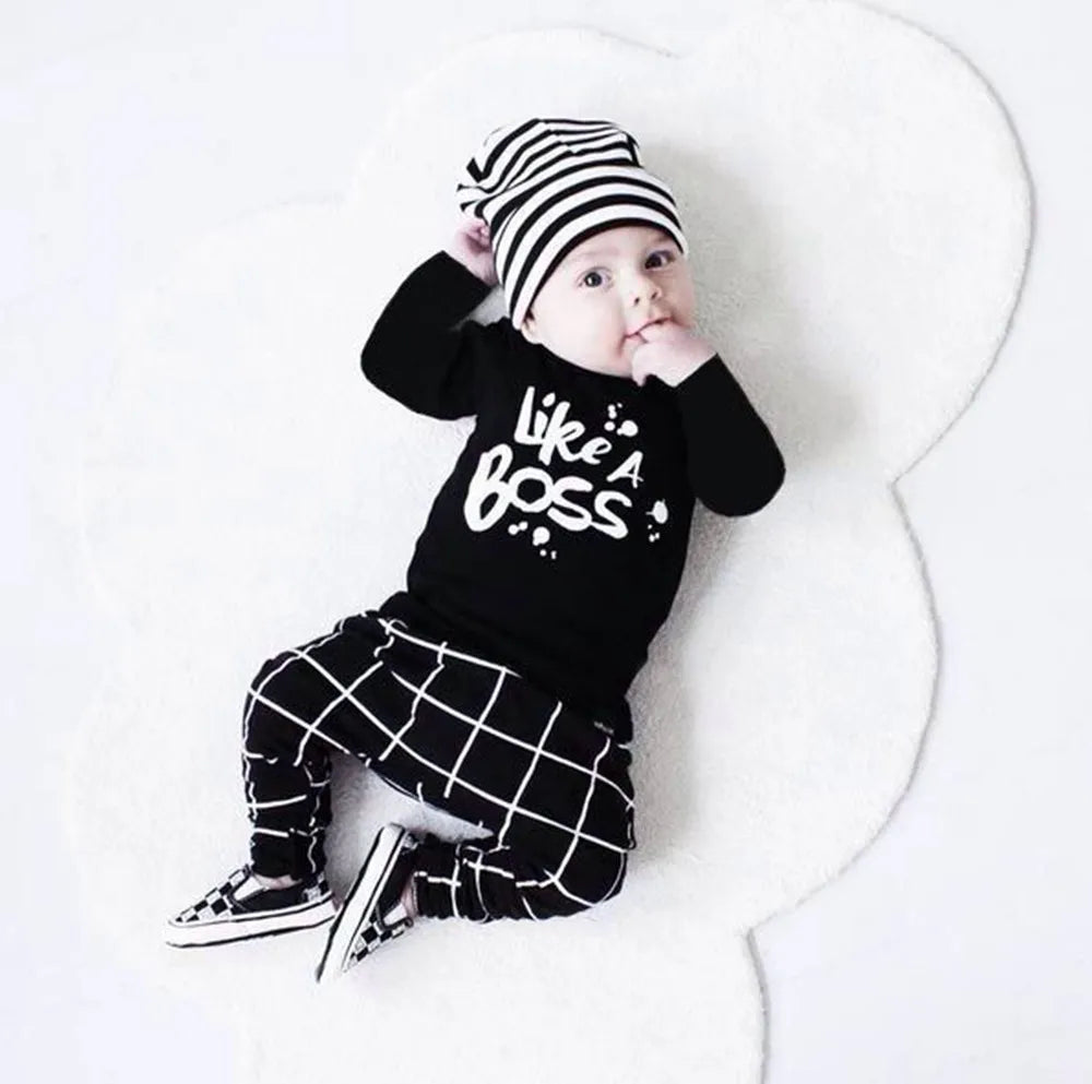 Baby boy wearing LIKE A BOSS Long Sleeve T-Shirt and Lattice Trousers Set with matching striped hat and shoes
