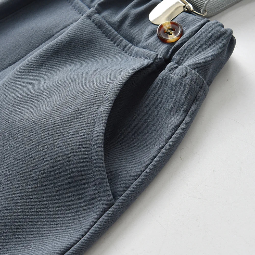 Close-up of gray suspender shorts pocket with button detail from Boys Casual Striped Shirt with Bowtie and Suspender Shorts Two-Piece Outfit