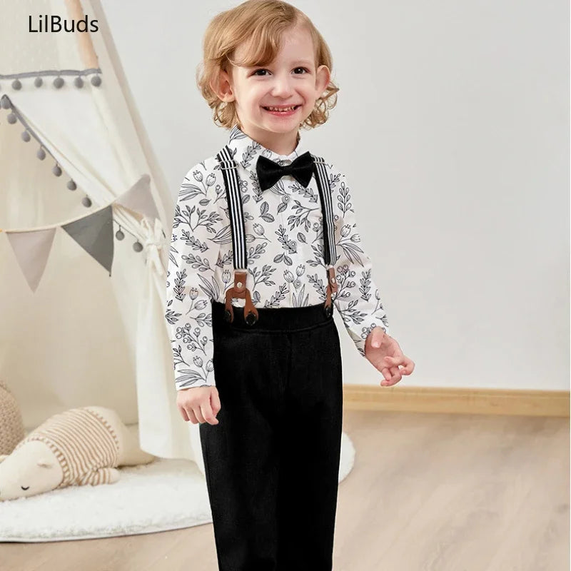 Smiling toddler boy wearing children top and bottom clothing set vest and pants with suspenders and bow tie