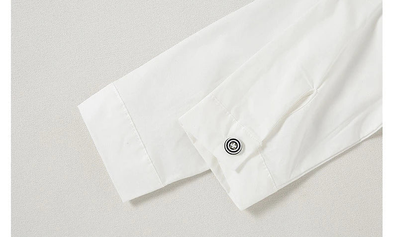 Close-up of white sleeves with button detail from Children Top And Bottom Clothing Set Vest & Pants by Yamza Tots' Closet