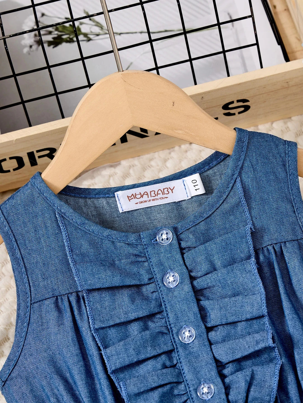 Fashion Girls Dress Summer Casual Patchwork Cowboy Butterfly Floral Design close-up of blue denim sleeveless dress with buttons on wooden hanger