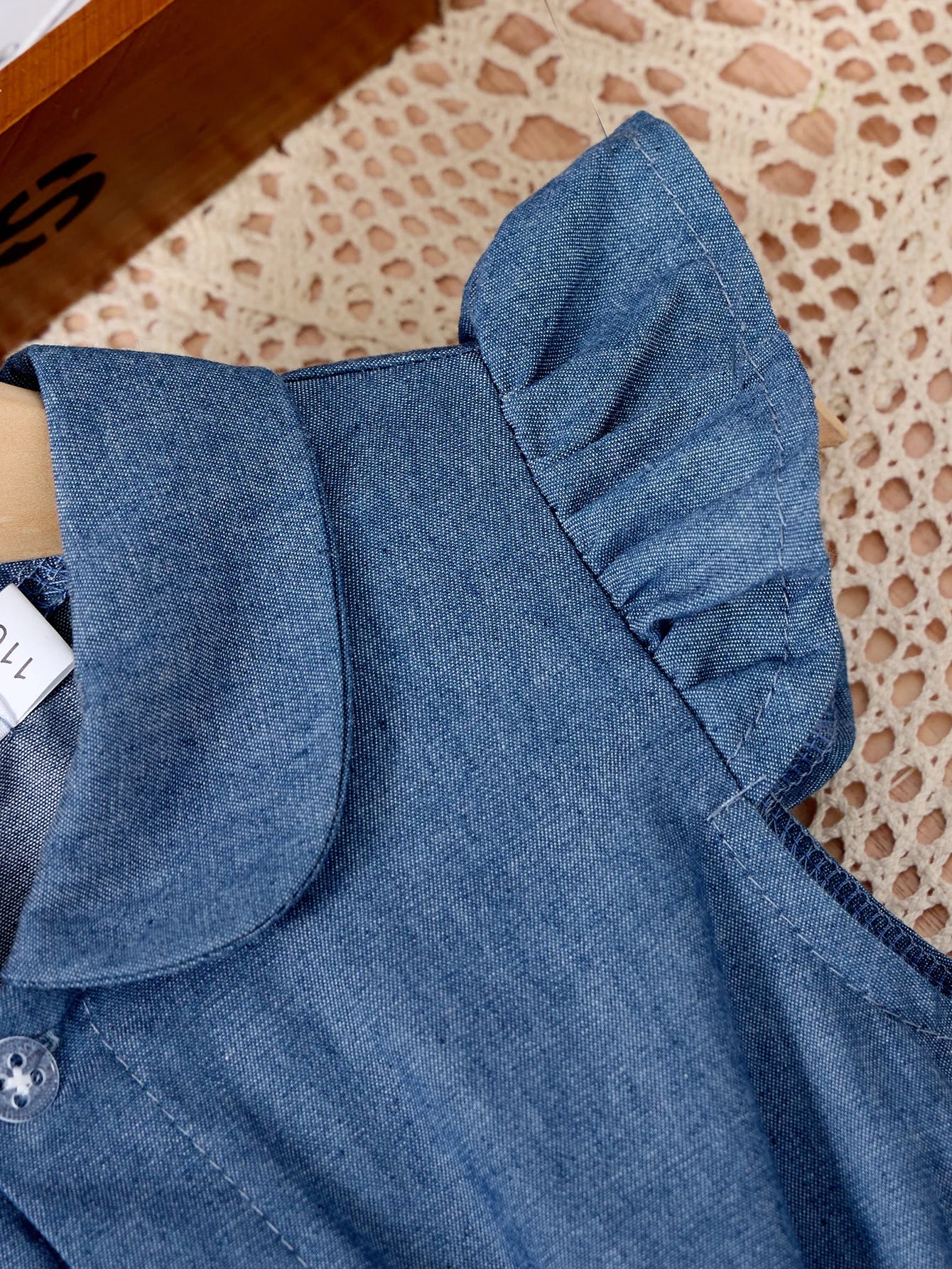 Close-up of blue denim fabric with ruffled sleeve detail from Fashion Girls Dress Summer Casual Patchwork Cowboy Butterfly Floral Design