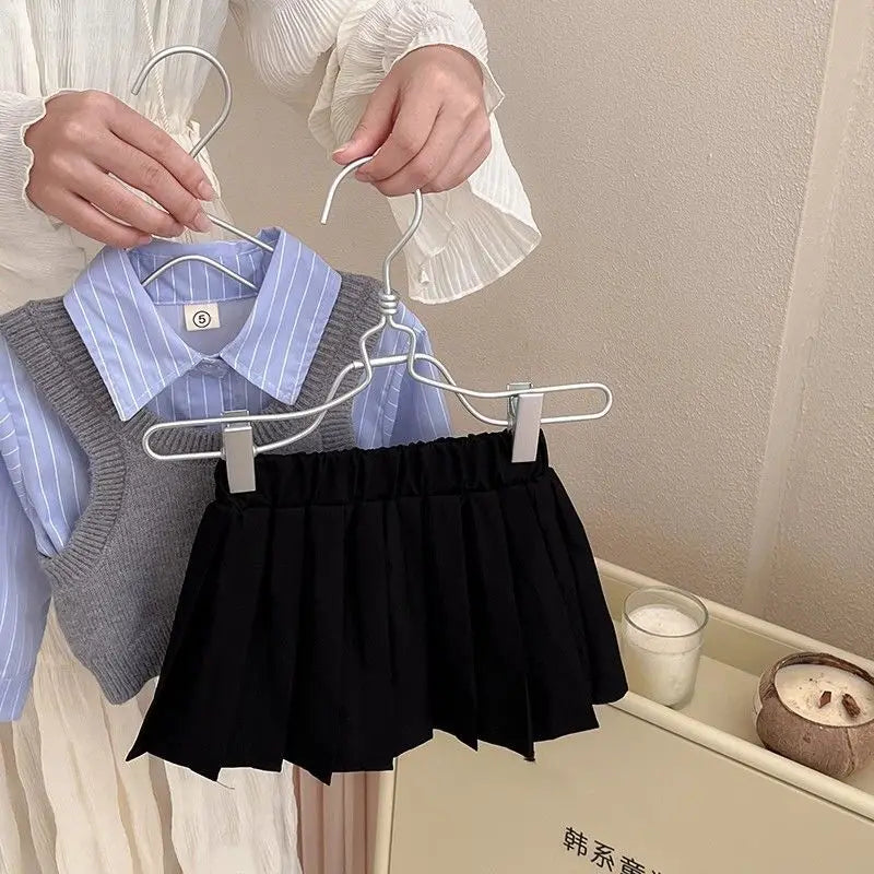 Fashion Baby Girl Set Shirt Vest and Pleated Skirt Toddler Outfit 2PCS displayed on hangers with blue shirt and grey vest