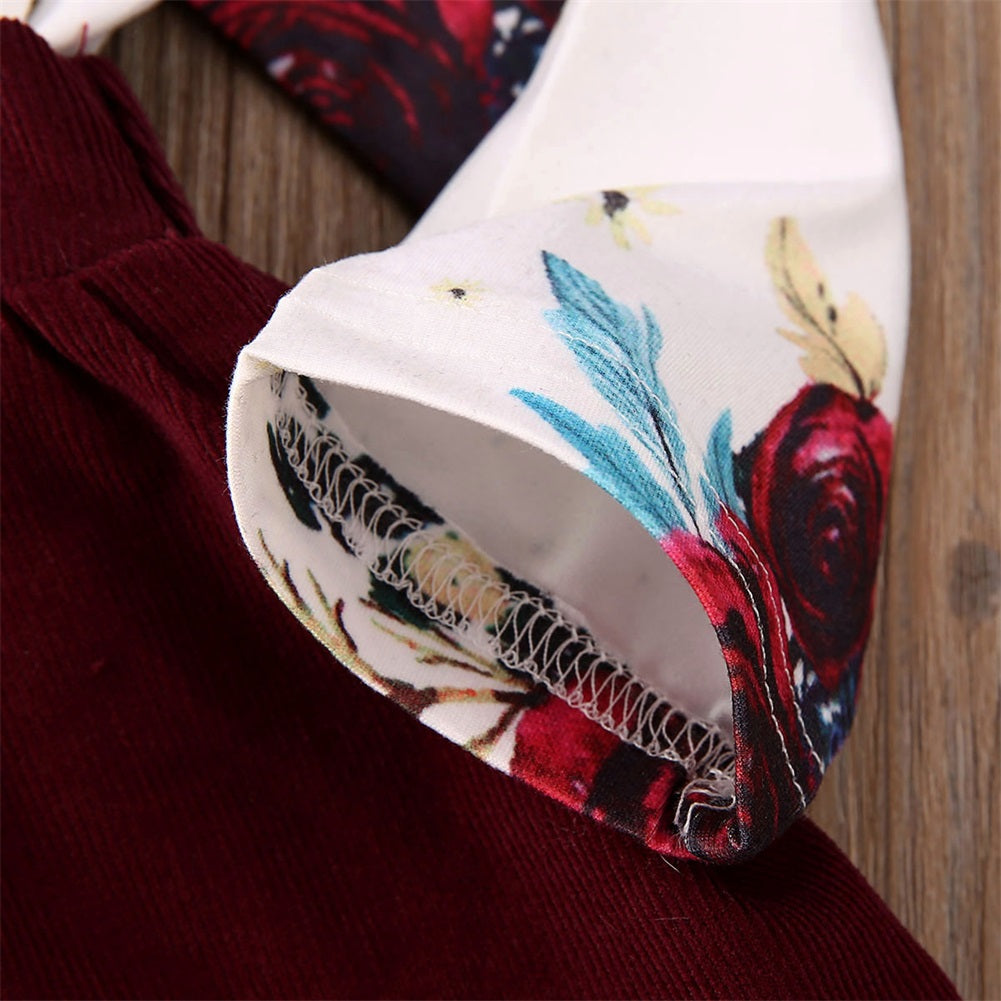 Close-up of Newborn Baby Girl Floral Bodysuit Set with Suspender Skirt and Bow Headband showing floral fabric and stitching details