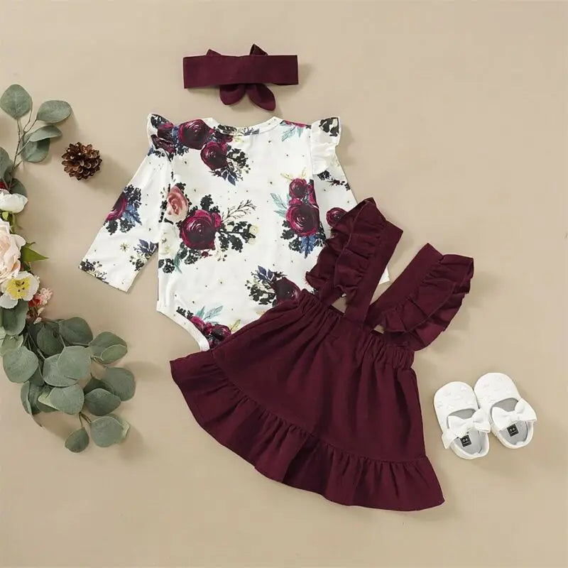 Newborn Baby Girl Floral Bodysuit Set with Suspender Skirt and Bow Headband in burgundy and cream colors