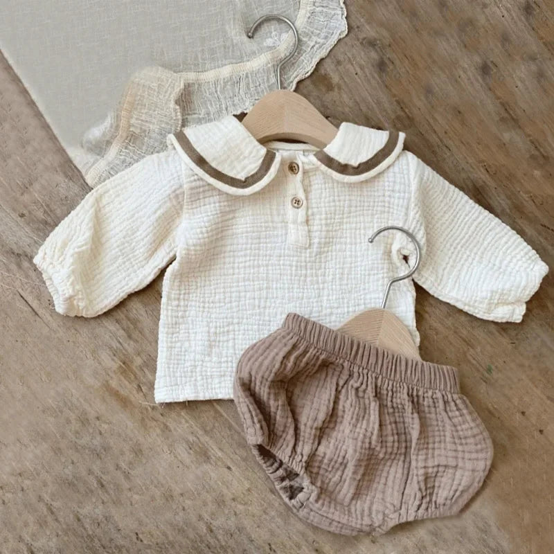 Organic Cotton Baby Boy Outfit Navy Shirt & Bloomers 2pcs Set in soft textured cream top and beige bloomers on wooden surface