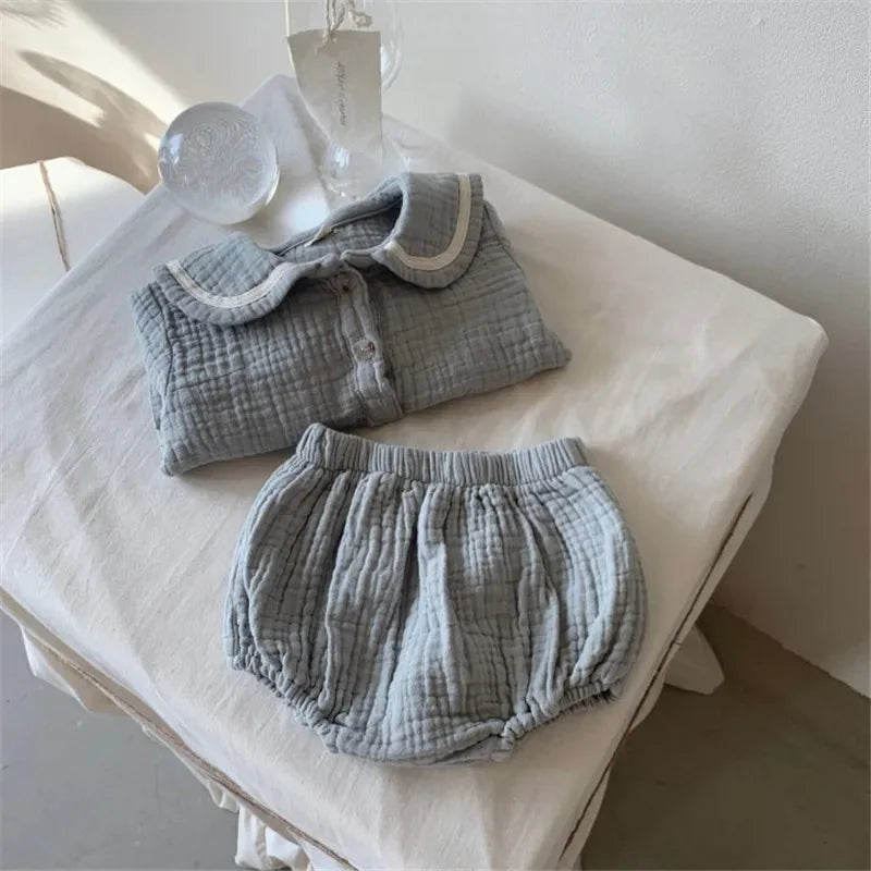 Organic Cotton Baby Boy Outfit Navy Shirt & Bloomers 2pcs Set folded on white cloth surface