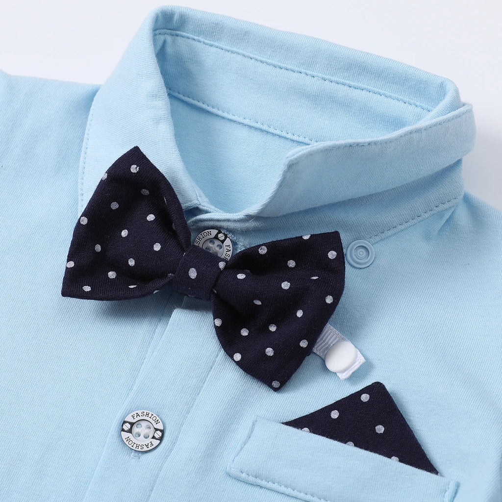 Light blue shirt with navy polka dot bow tie and pocket square for baby boys' formal wear.