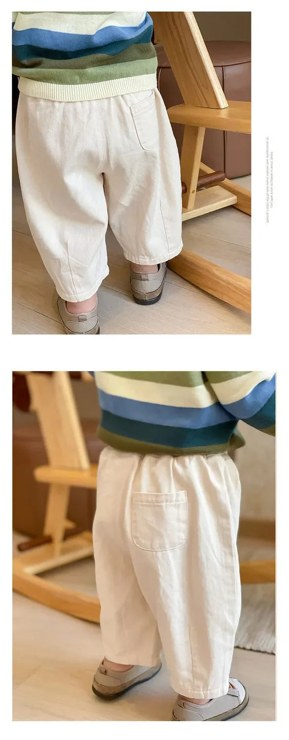 Solid Kids Fashion Trousers Casual Loose Pocket Ankle Length Pant for Boys Girls in white worn by child indoors 