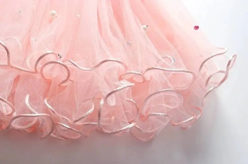 Close-up of pink tulle tutu skirt with ruffled edges and tiny decorative beads for Girls Summer Dress Set Cute Stitch T-Shirt and Tulle Tutu Skirt Outfit