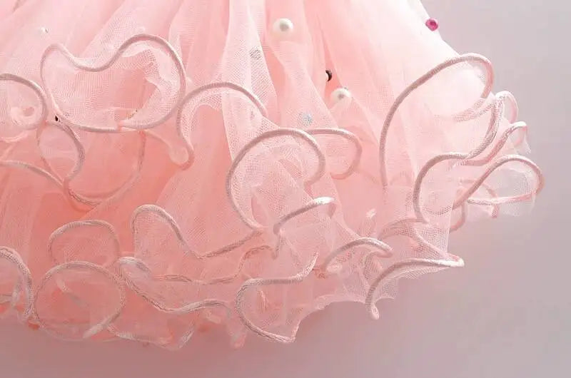 Close-up of pink tulle tutu skirt with ruffled edges in Girls Summer Dress Set Cute Stitch T-Shirt and Tulle Tutu Skirt Outfit
