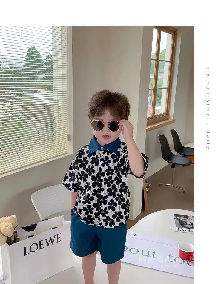 Child wearing Stylish Flower Suit for Children Baby Short Sleeve Shirt and Casual Shorts Set with black floral shirt and blue shorts