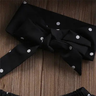 Close-up of black polka dot headband part of Toddler Baby Girls Black Blouse Top with Ripped Denim Pants Outfit Set