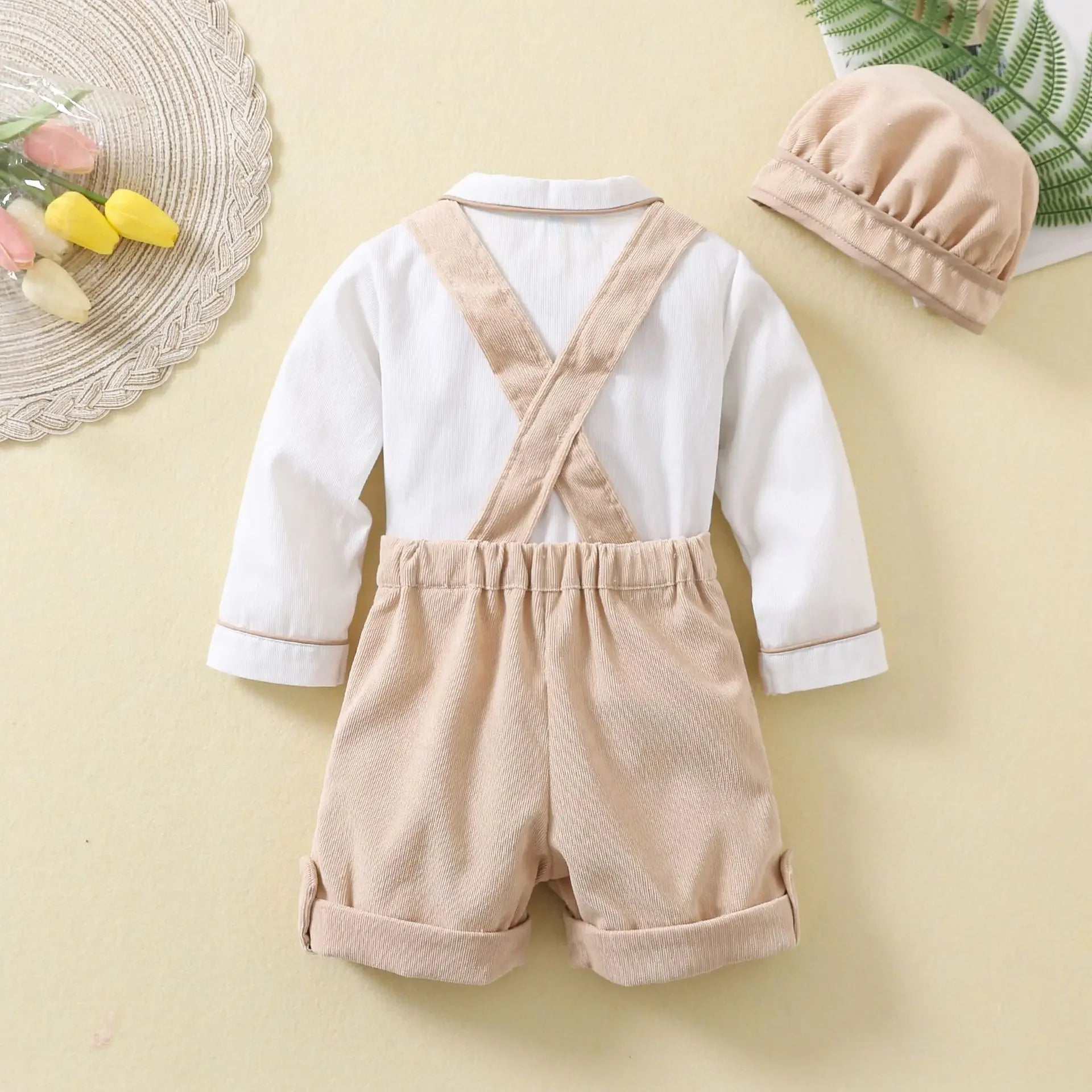 Toddler Boys Birthday Outfit with beige suspenders shorts, white long sleeve shirt, and matching cap