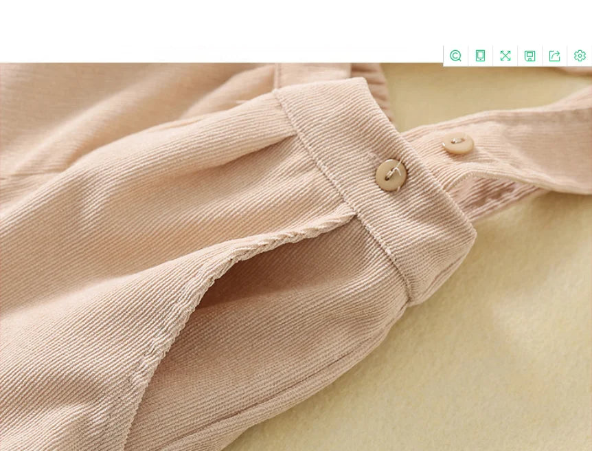 Close-up view of beige fabric and button detail on toddler boys birthday outfit by Yamza Tots Closet