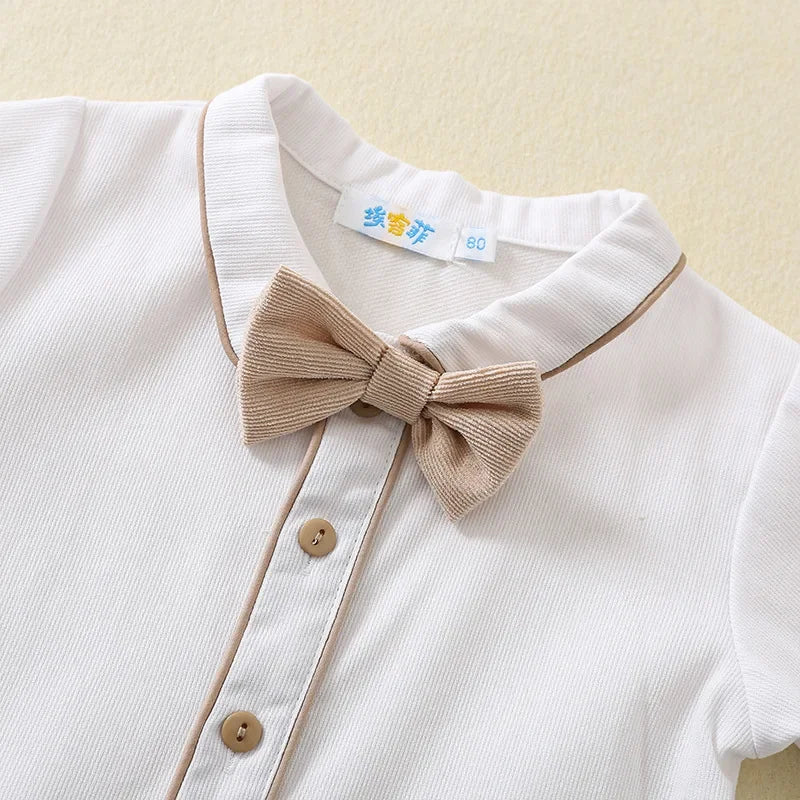 Toddler boys birthday outfit featuring a white shirt with beige bow tie and button details by Yamza Tots Closet