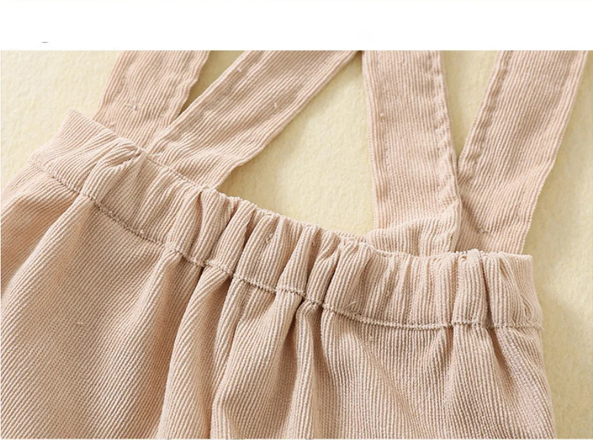 Close-up of beige corduroy fabric with adjustable straps on toddler boys birthday outfit by Yamza Tots' Closet