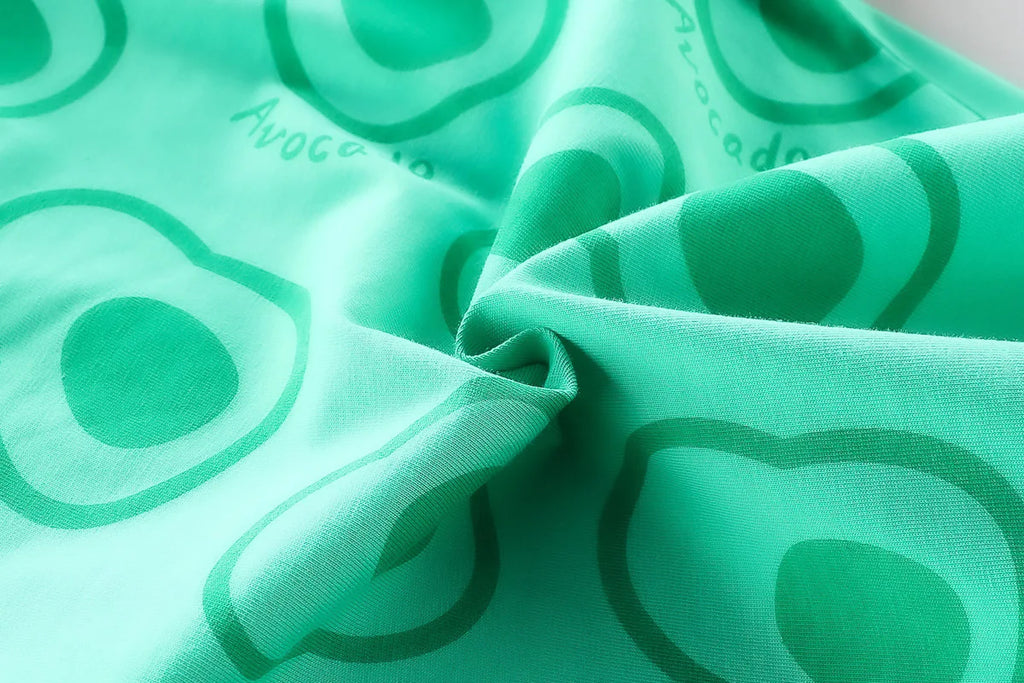 Close-up of green fabric with avocado print for Toddler Boys Fashion Outfit Set Printed T-Shirt and Denim Shorts