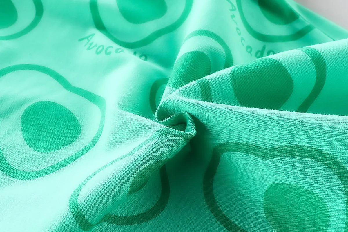 Close-up of green fabric with avocado print for Toddler Boys Fashion Outfit Set Printed T-Shirt and Denim Shorts