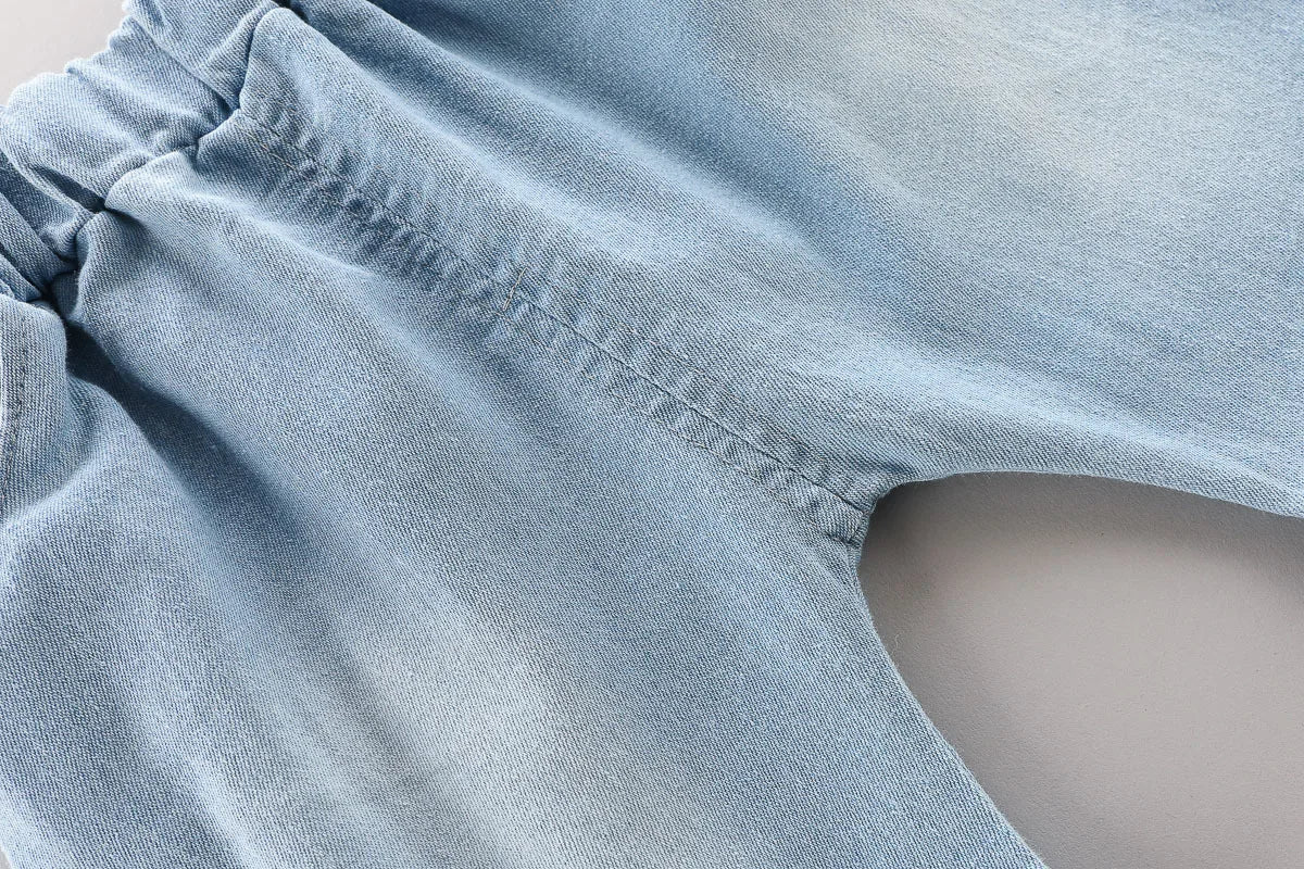 Close-up of denim shorts hem from Toddler Boys Fashion Outfit Set Printed T-Shirt Cartoon Bag Denim Shorts 