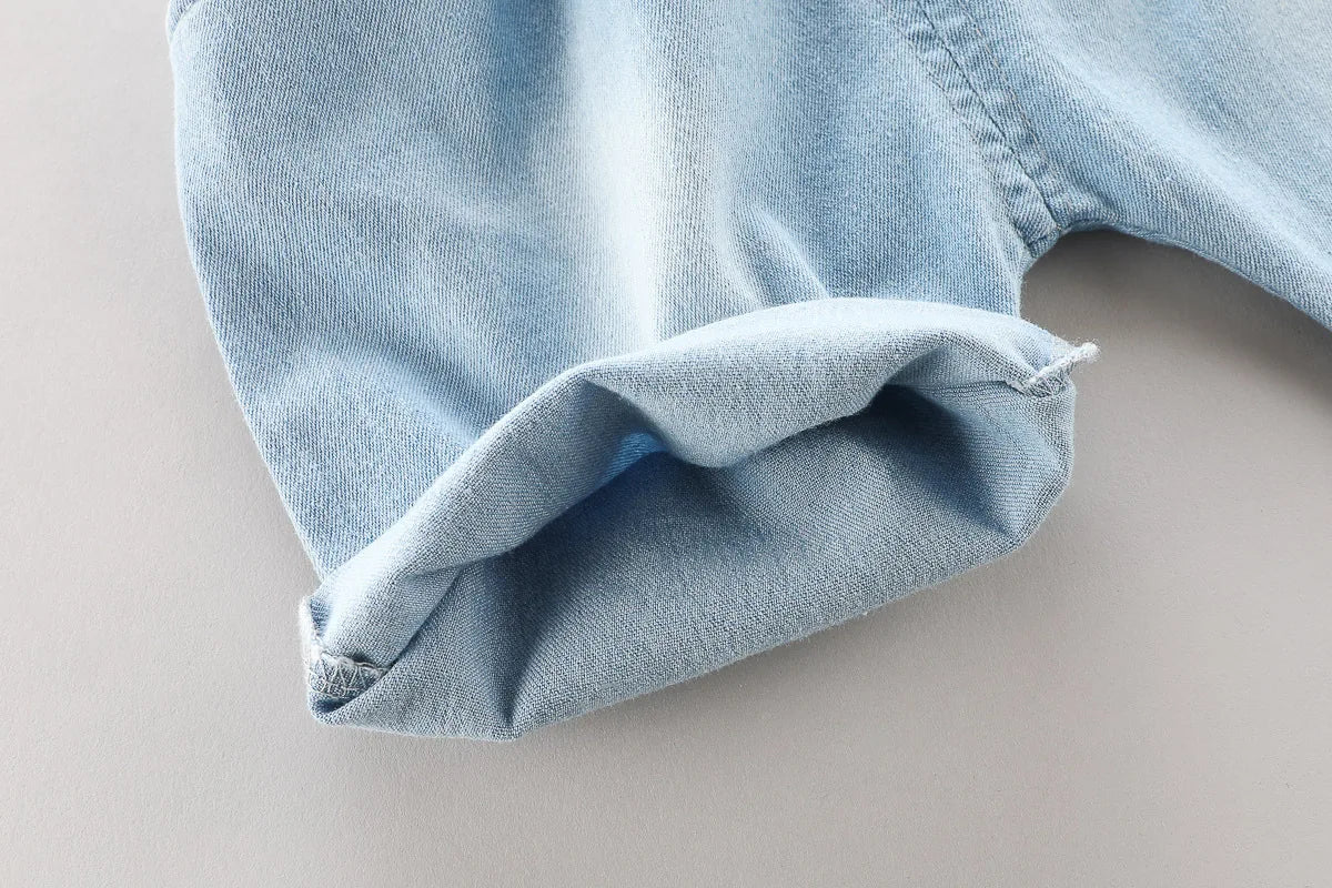 Close-up of denim shorts leg detail from Toddler Boys Fashion Outfit Set Printed T-Shirt Cartoon Bag Denim Shorts